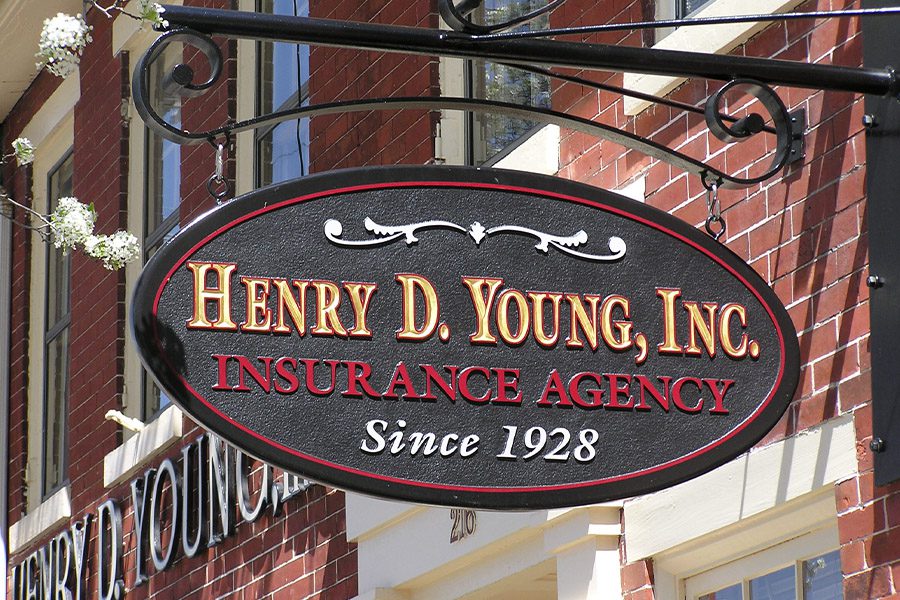 Contact - Closeup of the Henry D Young Inc Insurance Office Sign On a Bright Sunny Day